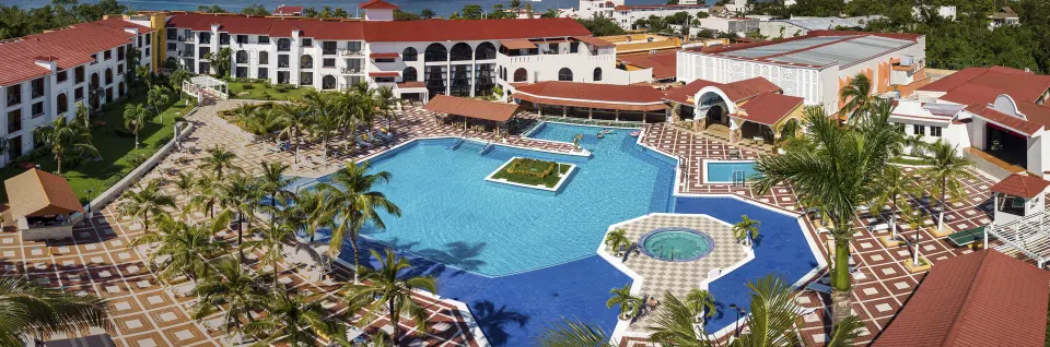 Aerial panoramic view of resort pool and tiled courtyard at Cozumel Hotel & Resort