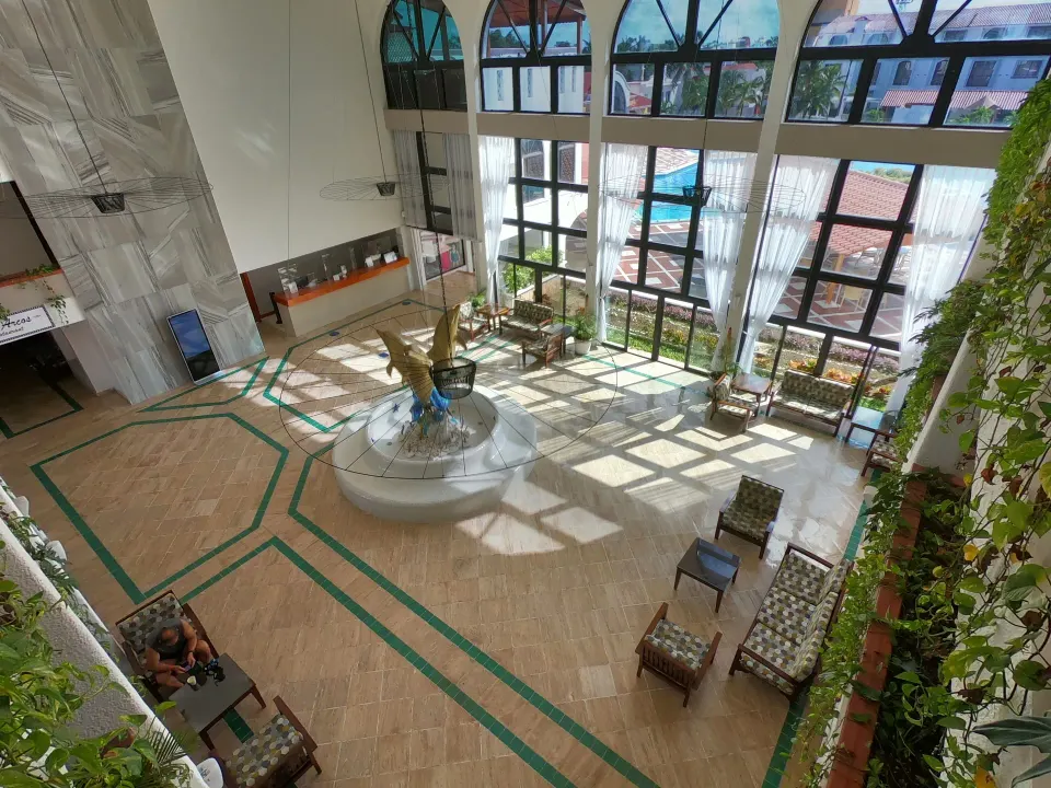 High-angle view of the lobby showing seating, fountain and reception desk at Cozumel Hotel & Resort