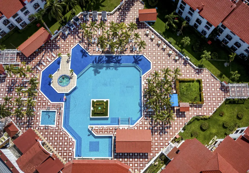 Aerial view of the resort's main pool and surrounding red-roofed buildings at Cozumel Hotel & Resort