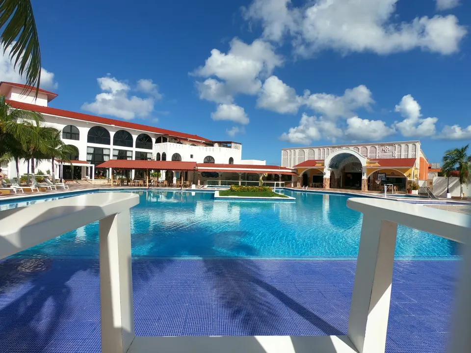 Resort swimming pool with terrace and arched buildings at Cozumel Hotel & Resort