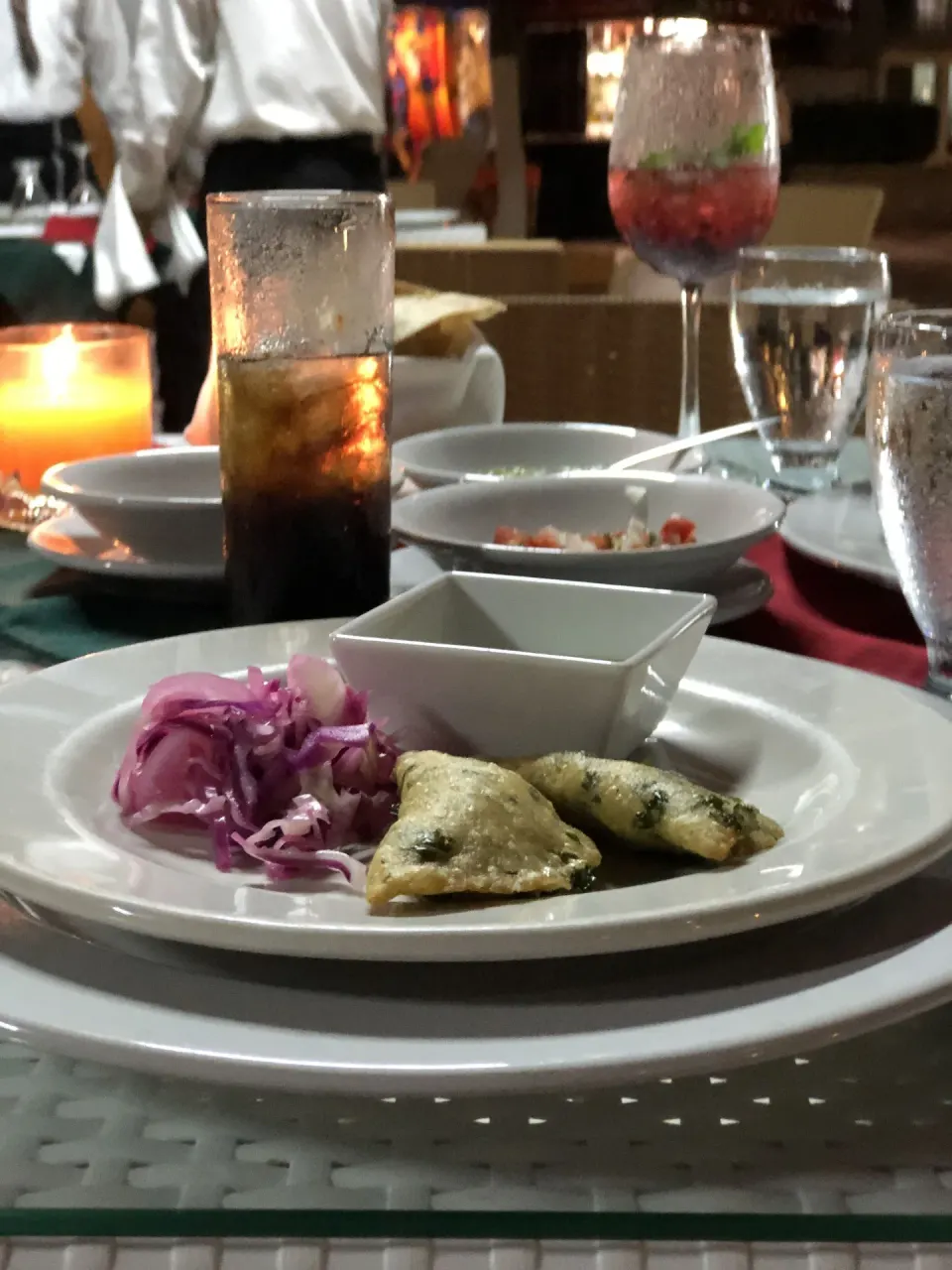 Appetizer plate with empanadas and pickled onions on a table at Cozumel Hotel & Resort