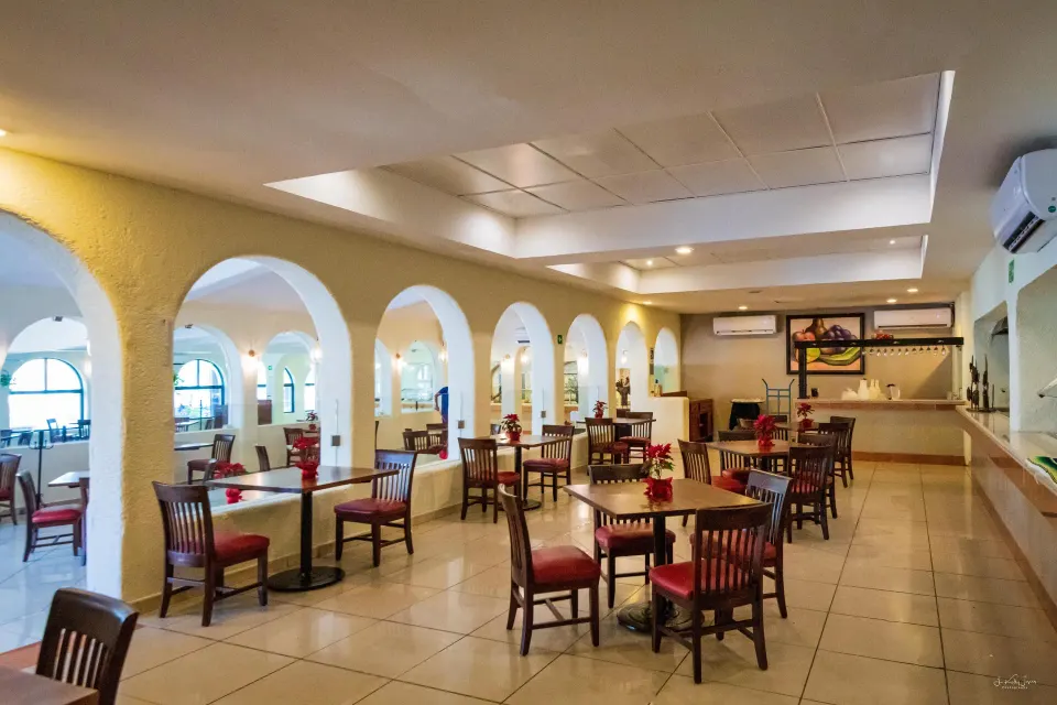 Spacious indoor dining room with arched openings at Cozumel Hotel & Resort