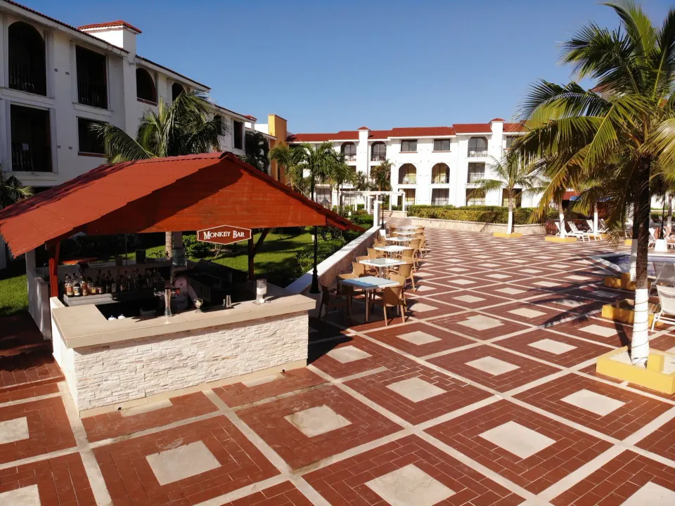 Outdoor poolside bar and tiled courtyard at Cozumel Hotel & Resort