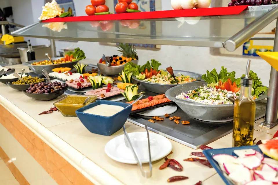 Buffet selection of salads and condiments on a self-serve counter at Cozumel Hotel & Resort
