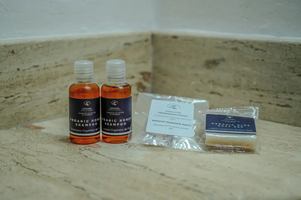 Assorted travel-size bath amenities arranged on a bathroom counter at Cozumel Hotel & Resort.