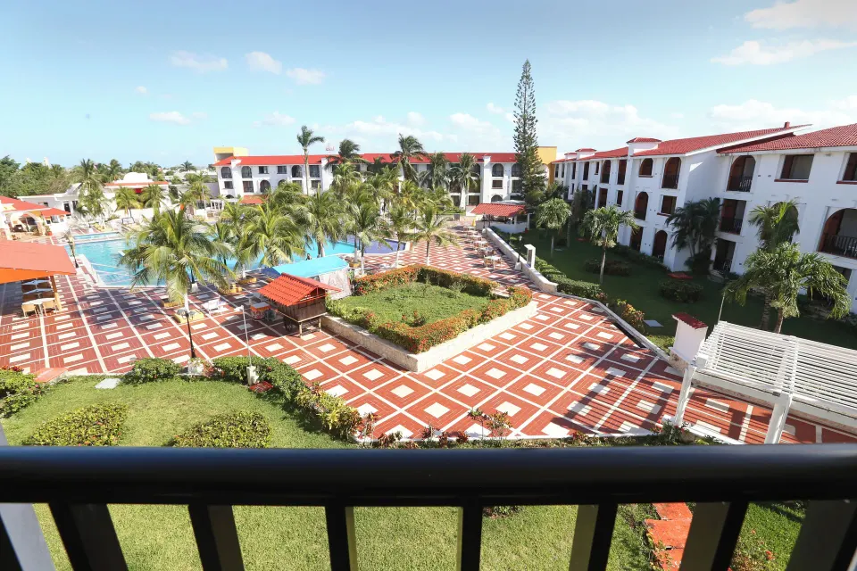 View of the resort pool and tiled courtyard from a balcony at Cozumel Hotel & Resort.