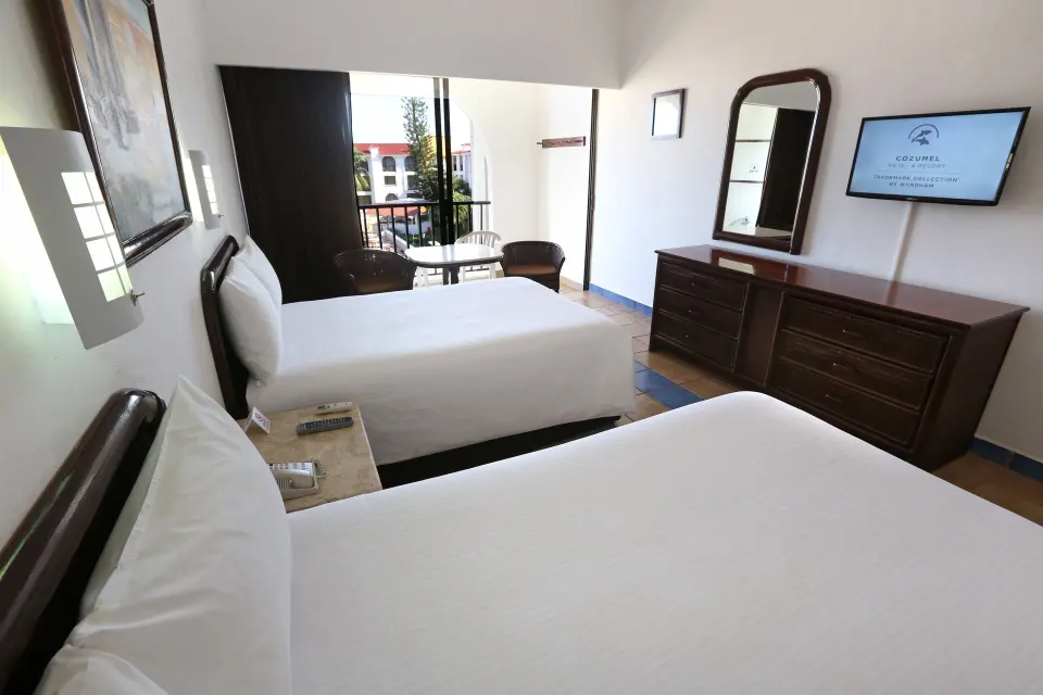 Standard room with two double beds and balcony at Cozumel Hotel & Resort.