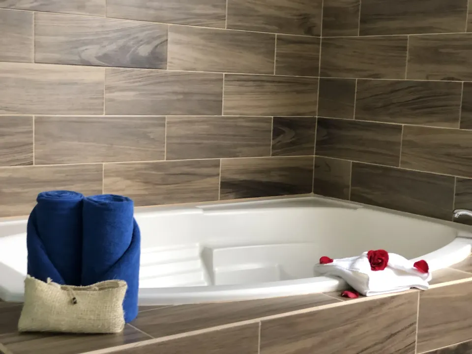 Close-up of the jacuzzi tub and folded towels at Cozumel Hotel & Resort