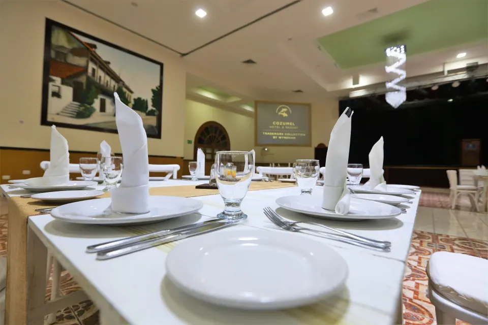 Close-up of a formally set dining table in the event hall at Cozumel Hotel & Resort