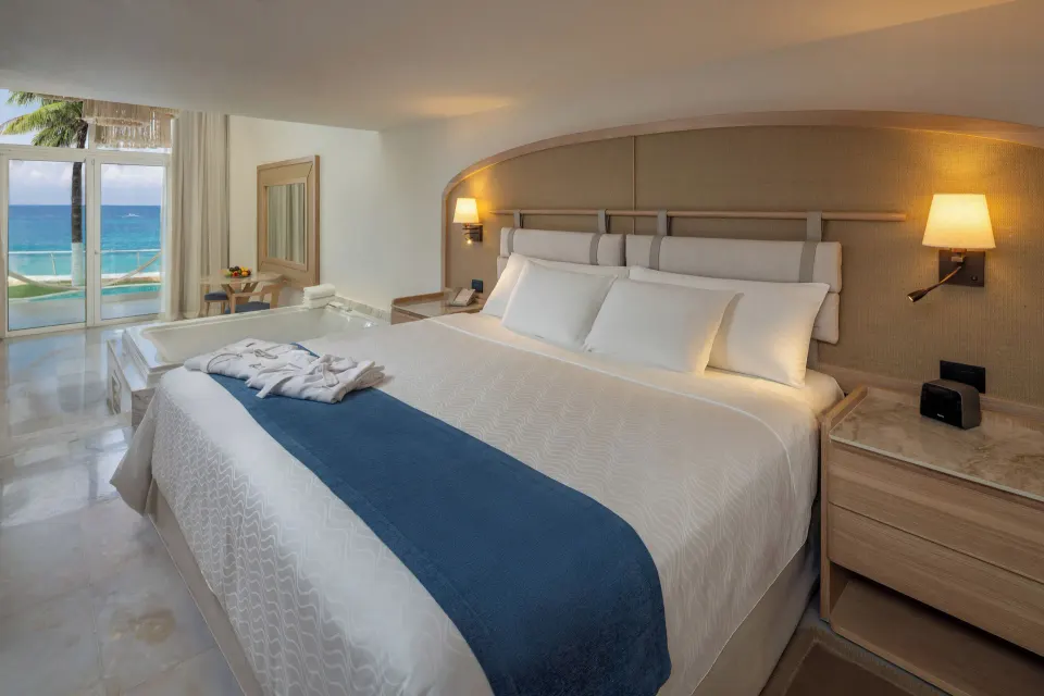 King bedroom with balcony and ocean view at Cozumel Palace.