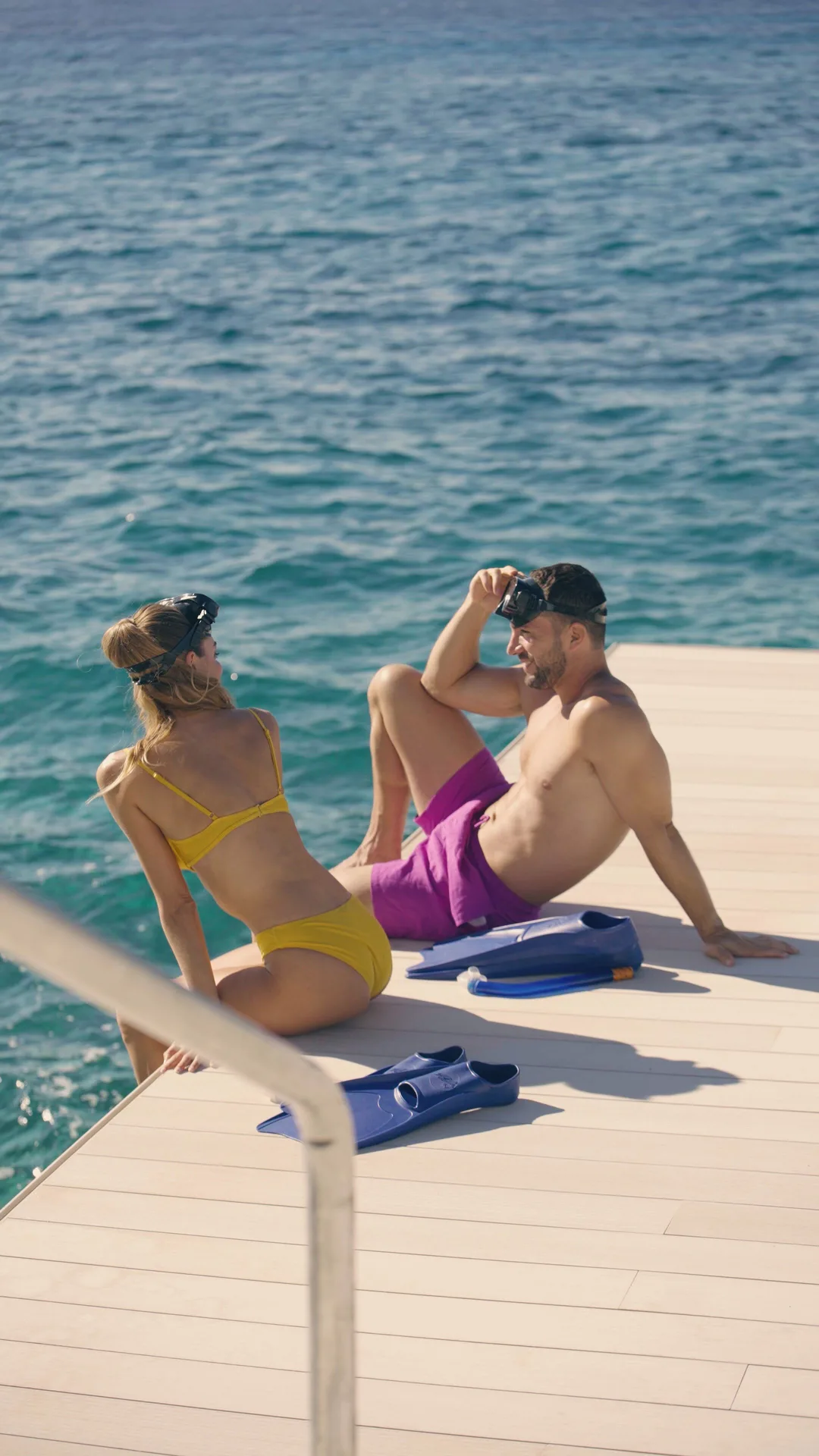 Two guests relaxing on the resort dock near the ocean at Cozumel Palace