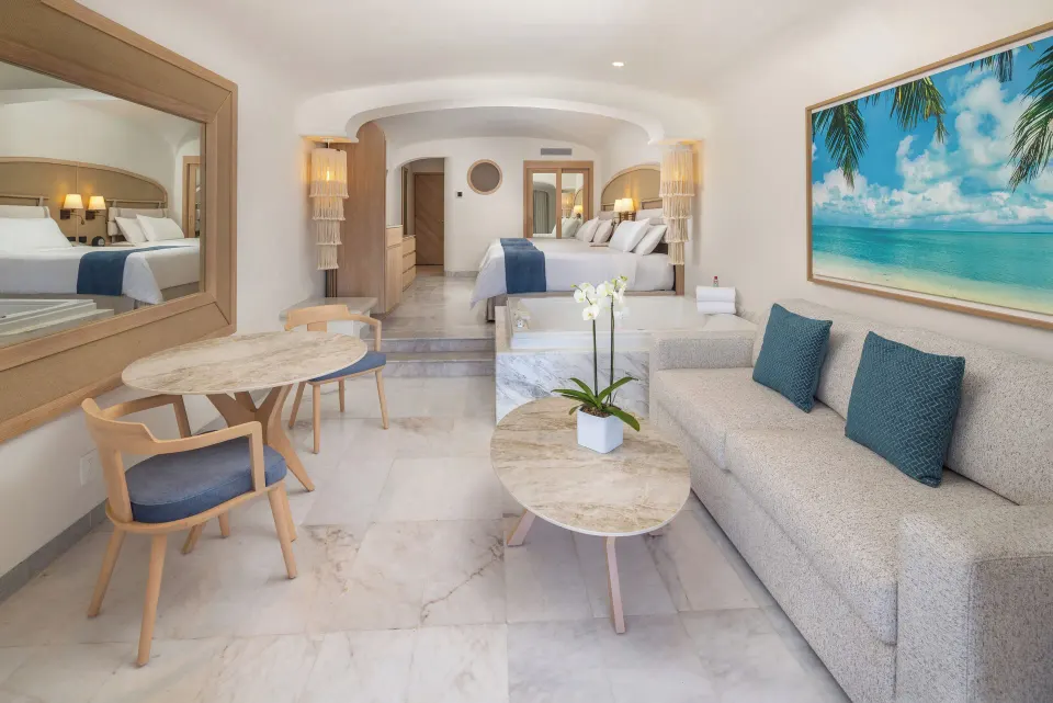 Living area and sofa with artwork in a suite at Cozumel Palace.