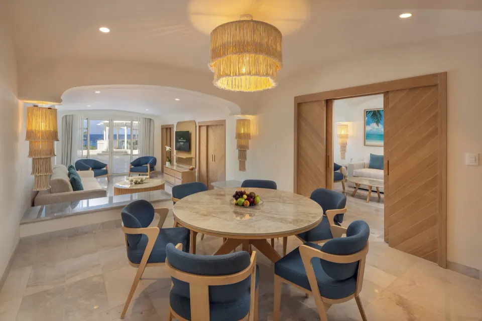 Suite dining and living space with sliding doors at Cozumel Palace.