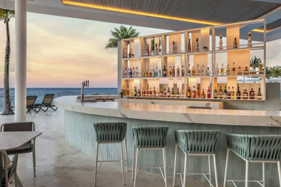 Oceanfront swim-up bar with backlit bottle display at Cozumel Palace