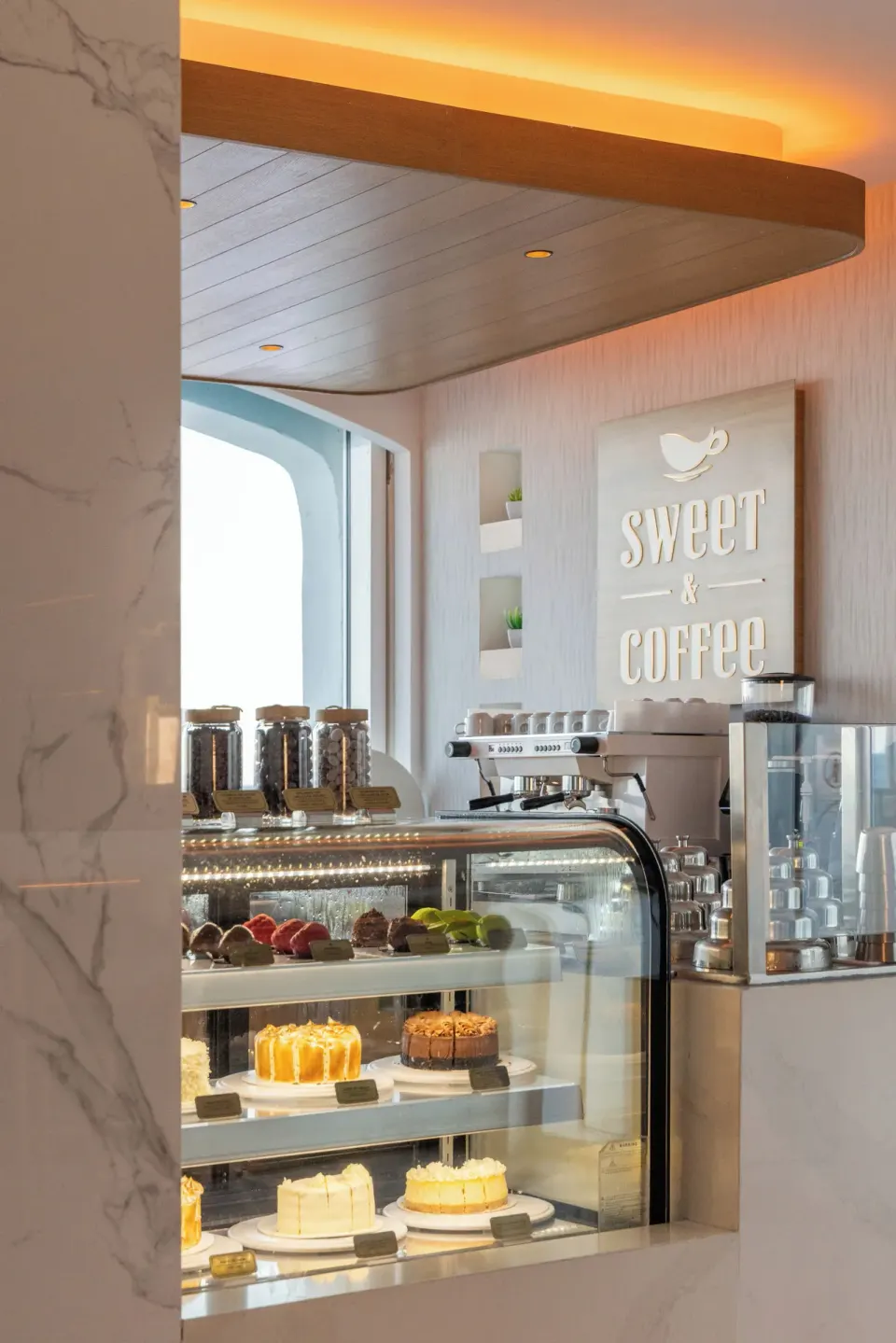 Pastry case and 'sweet & coffee' sign at Cozumel Palace