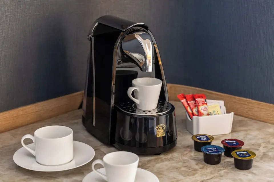 In-room coffee machine and cups on marble countertop in a Superior Honeymoon Suite at Cozumel Palace