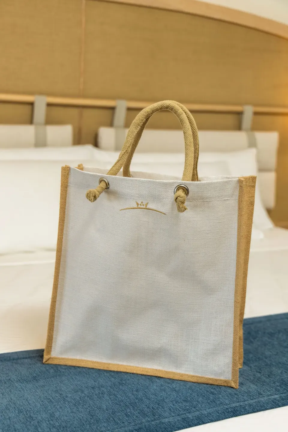 Welcome tote bag on the king bed in a Superior Honeymoon Suite at Cozumel Palace