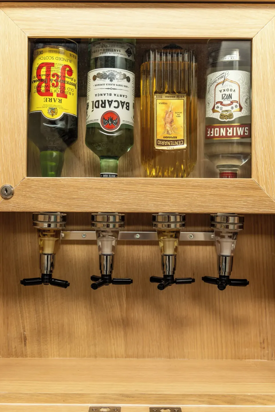 In-room liquor dispenser with four bottles at Cozumel Palace