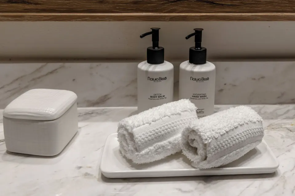 Marble vanity with rolled towels and bath amenities at Cozumel Palace