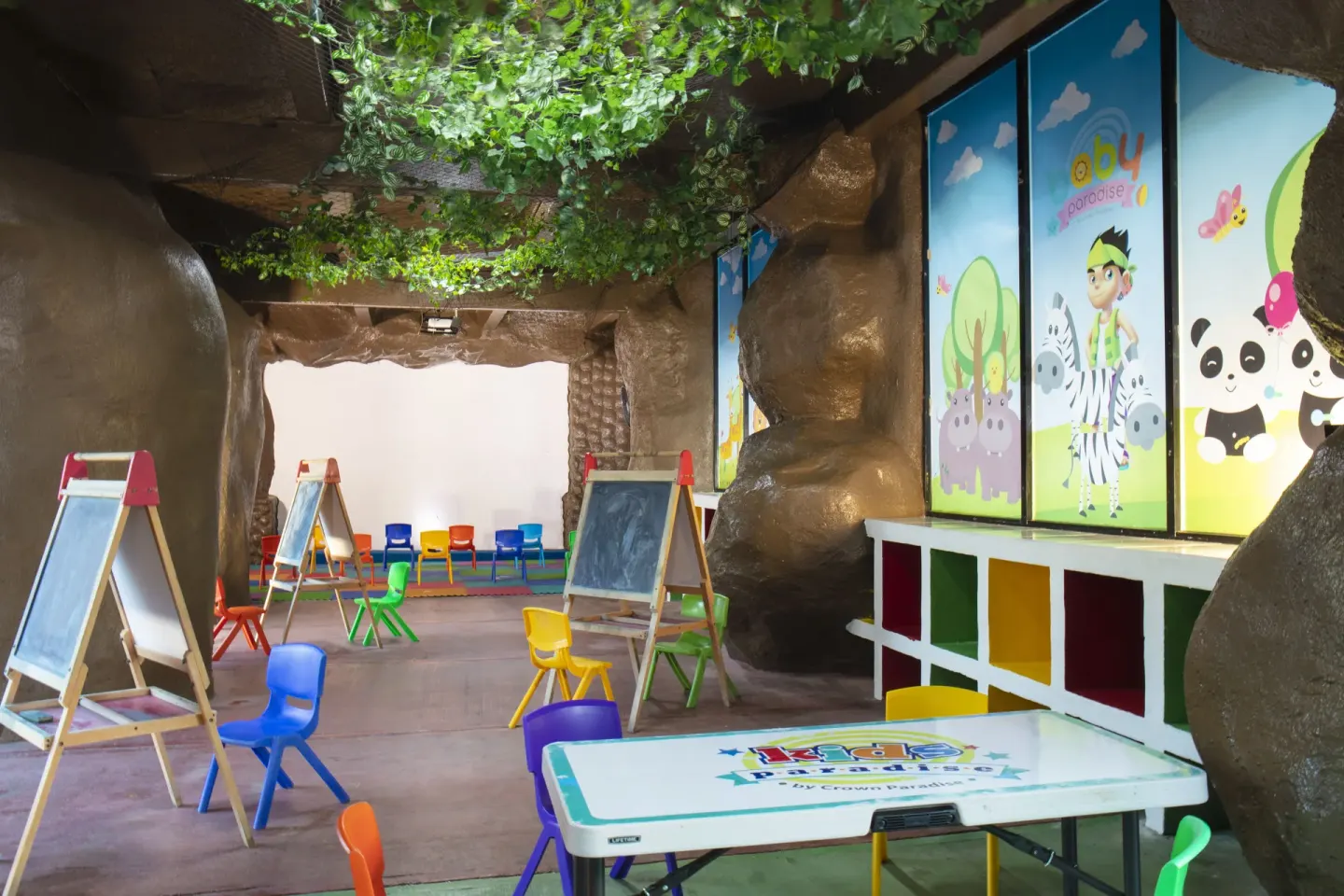 Children’s activity room with easels and small chairs at Crown Paradise Club Cancun.