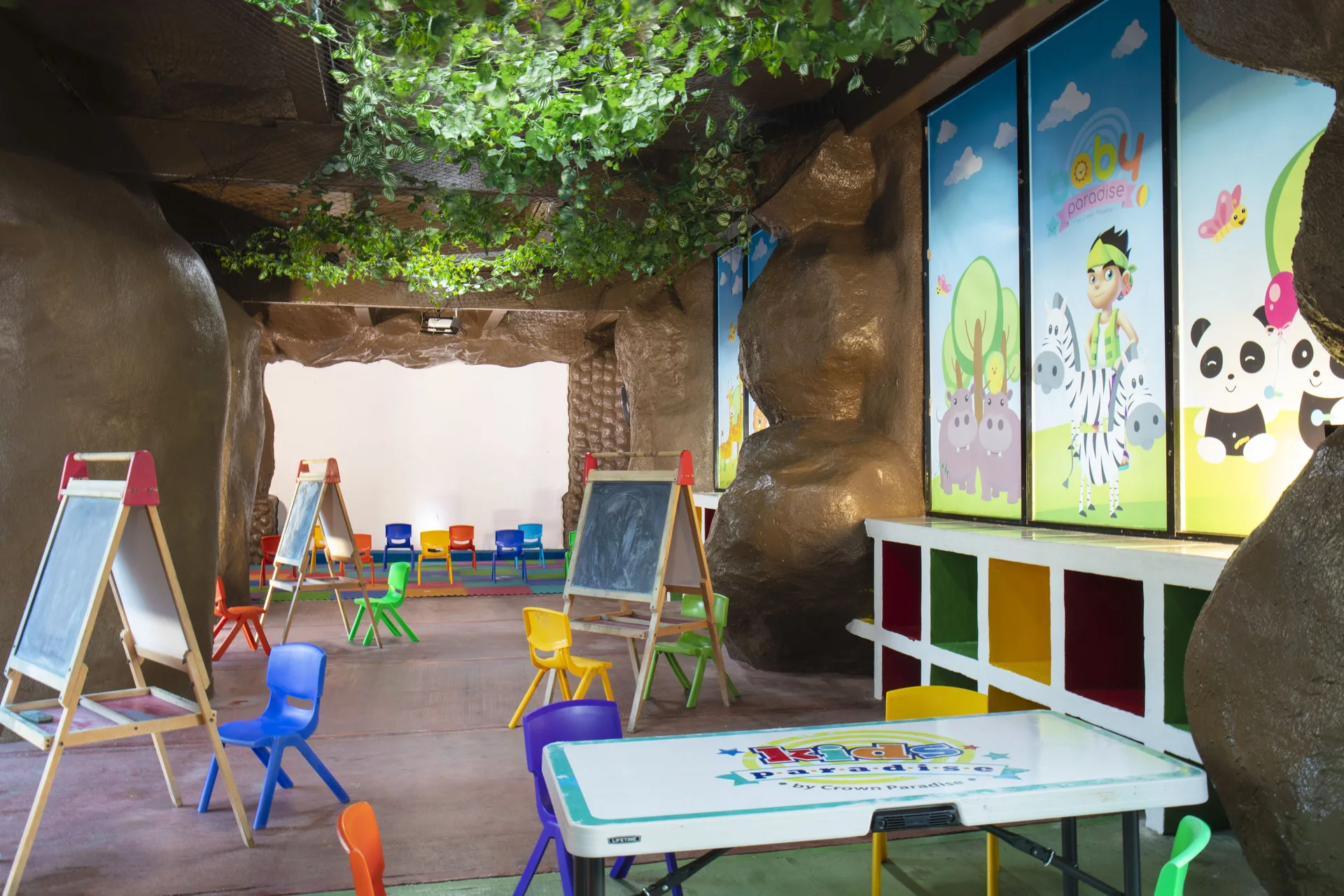 Children’s activity room with easels and small chairs at Crown Paradise Club Cancun.