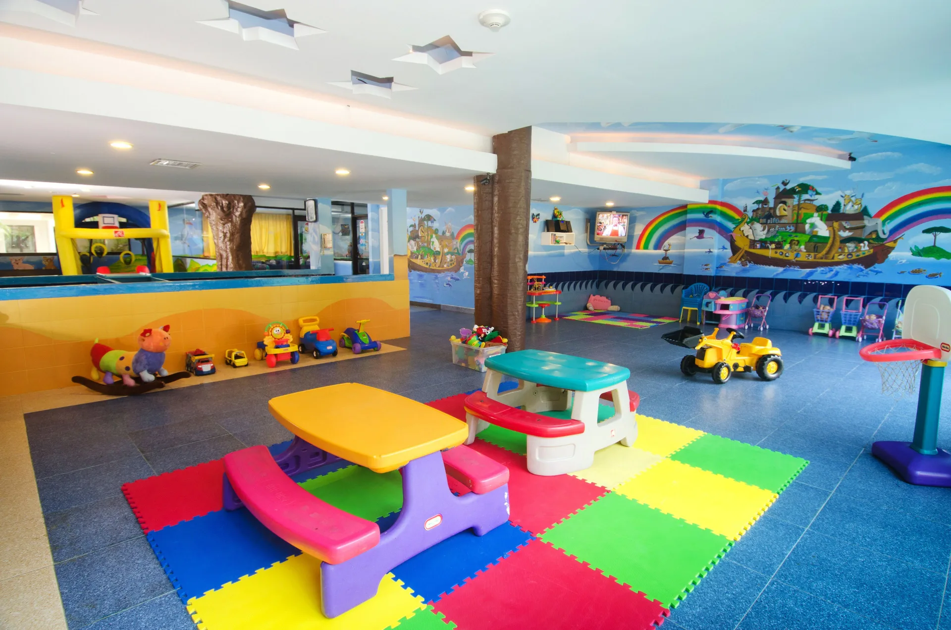 Colorful indoor kids playroom with toys at Crown Paradise Club Cancun.