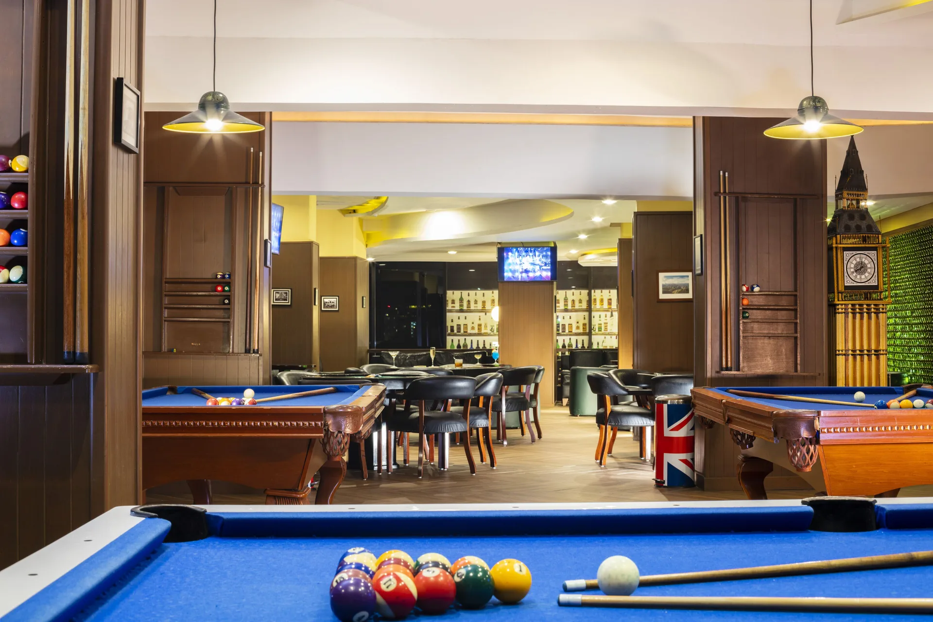 Billiards lounge with blue pool tables at Crown Paradise Club Cancun.