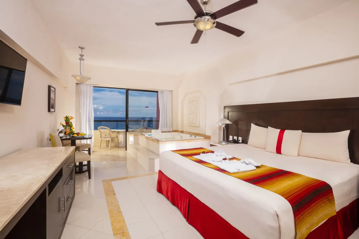 Crown Paradise Club Cancun at Crown Paradise Club Cancun with king bed, in-room tub, balcony and ocean view.