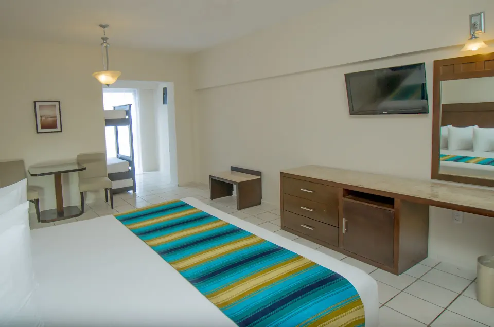 Crown Paradise Club Cancun king bed with bunk beds visible at Crown Paradise Club Cancun.