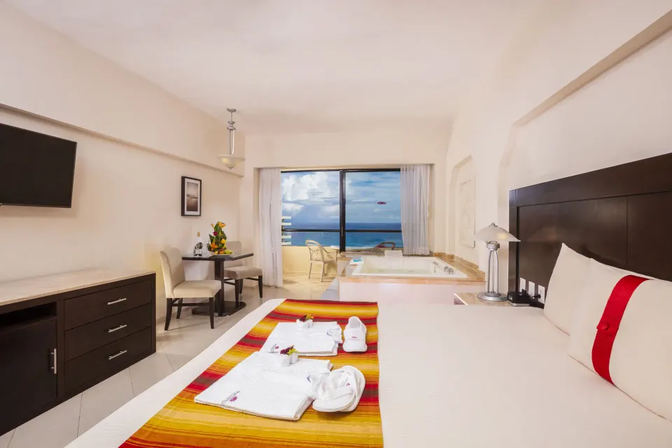 Crown Paradise Club Cancun with king bed, whirlpool tub, balcony, and ocean view at Crown Paradise Club Cancun.