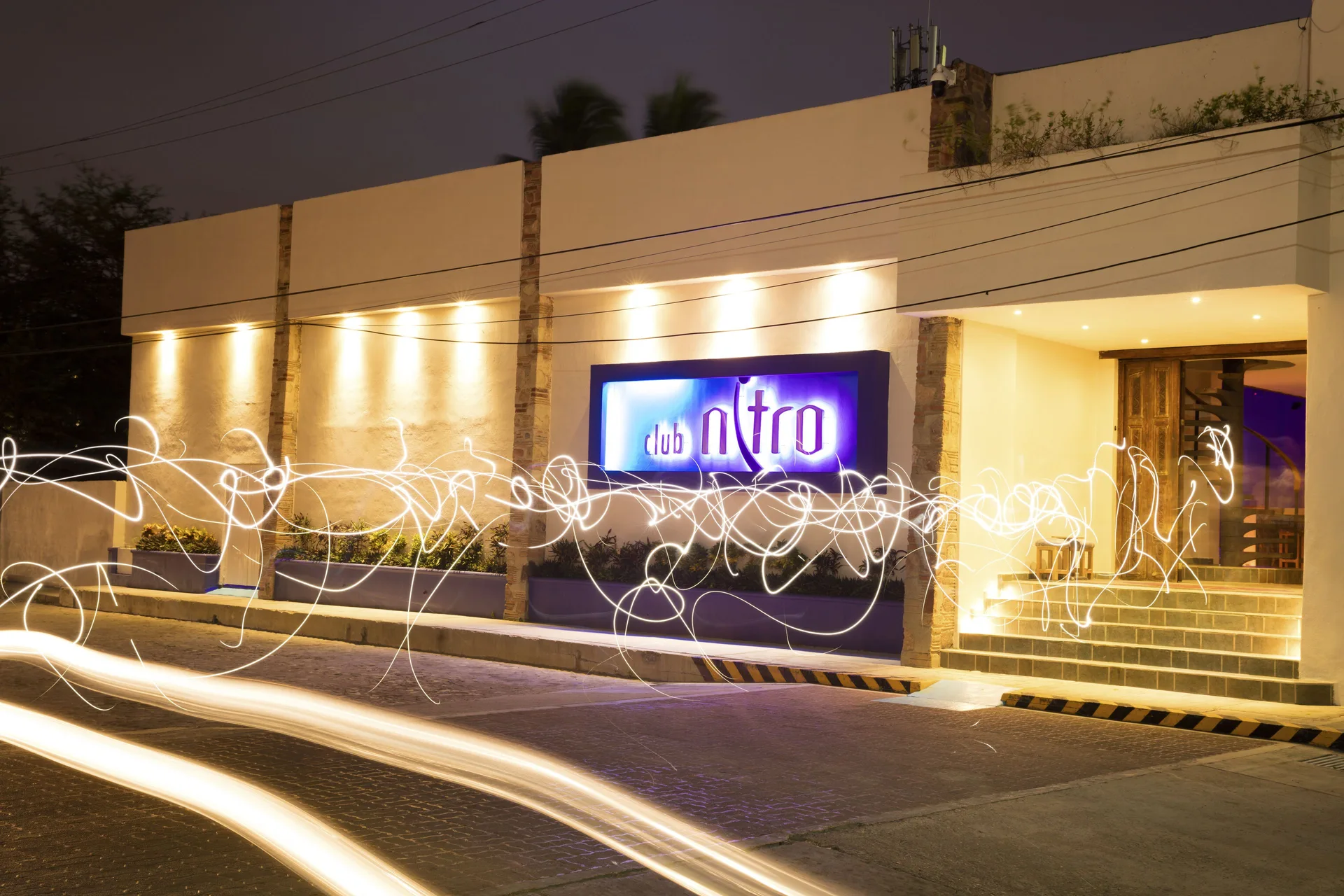 Club Nitro exterior entrance lit at night at Crown Paradise Club Puerto Vallarta.