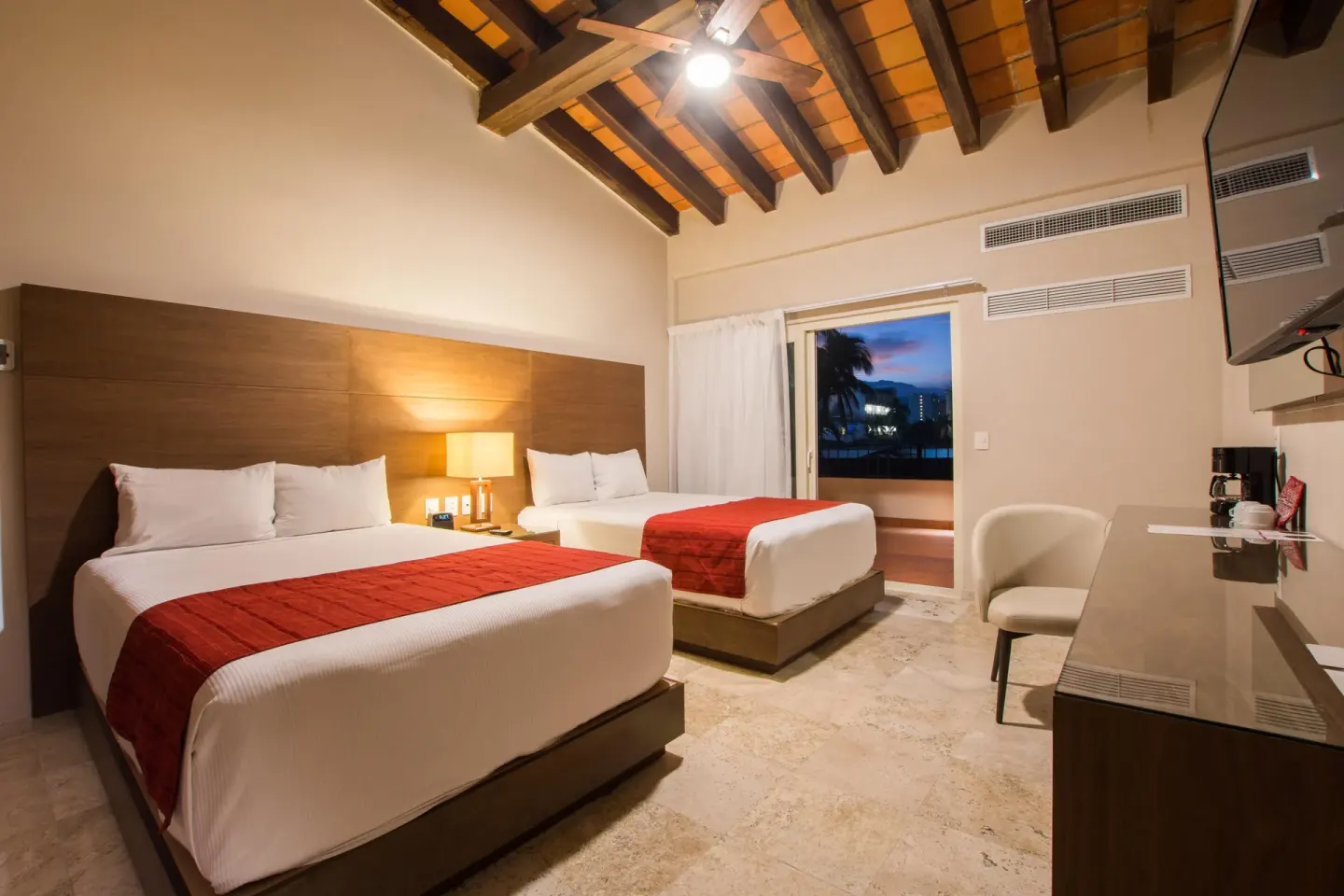 Two-bed guest room with vaulted ceiling at Crown Paradise Club Puerto Vallarta.