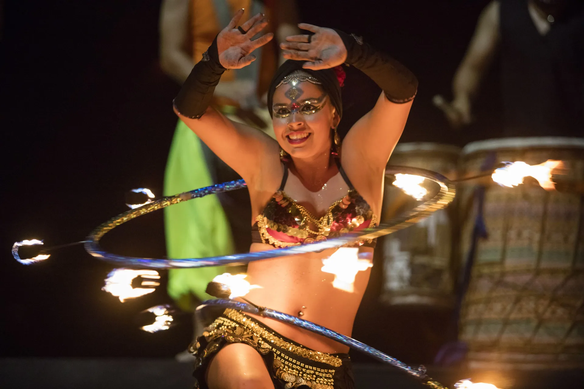 Fire hoop dancer performing at night at Crown Paradise Club Puerto Vallarta.