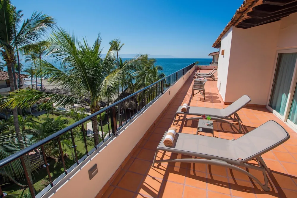 Ocean-view terrace with lounge chairs at Crown Paradise Club Puerto Vallarta.