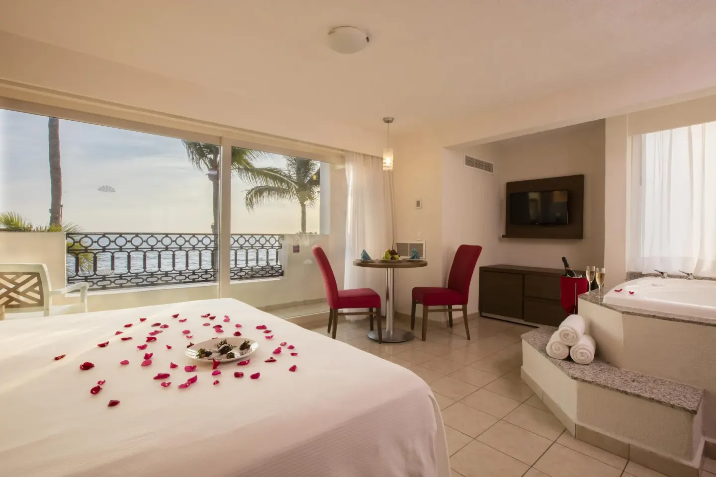Oceanfront suite with king bed and in-room tub at Crown Paradise Club Puerto Vallarta.