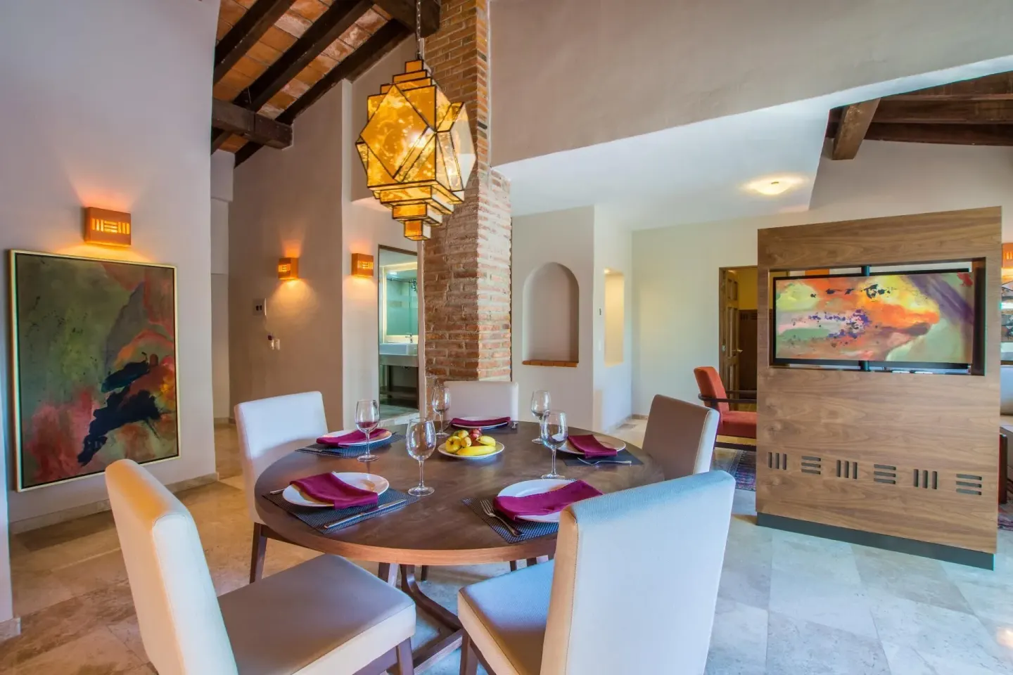 Suite dining area with round table at Crown Paradise Club Puerto Vallarta.