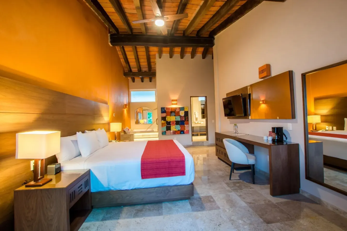 King bed suite with desk and vanity area at Crown Paradise Club Puerto Vallarta.