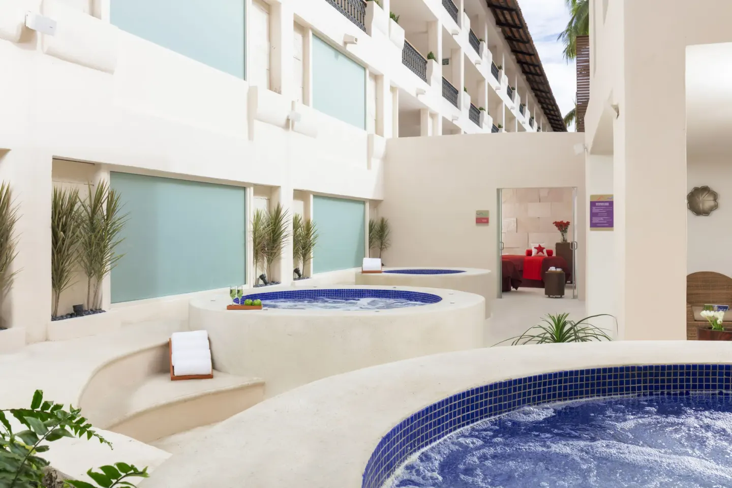 Private whirlpool terraces outside suites at Crown Paradise Club Puerto Vallarta.