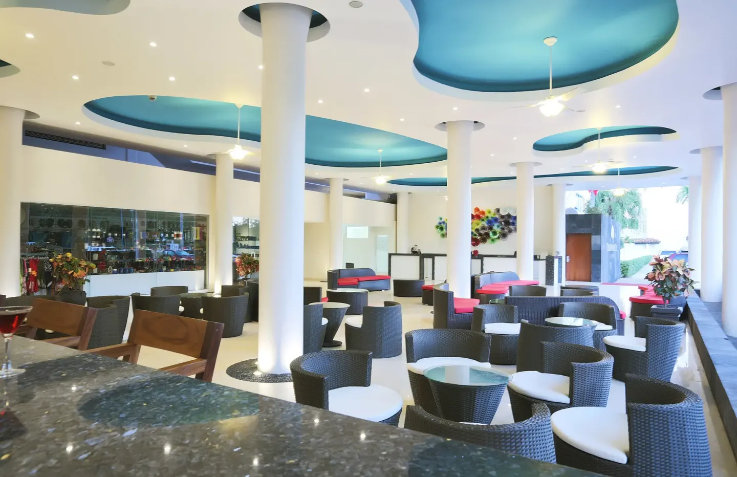 Open lounge bar seating area with teal ceiling accents at Crown Paradise Club Puerto Vallarta.