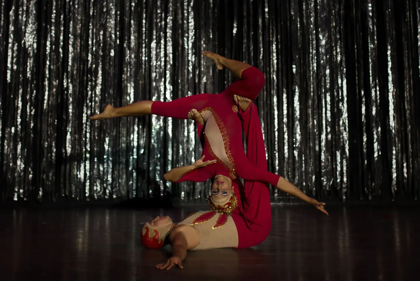 Acrobatic performers in red costumes on a stage at Crown Paradise Golden Resort.