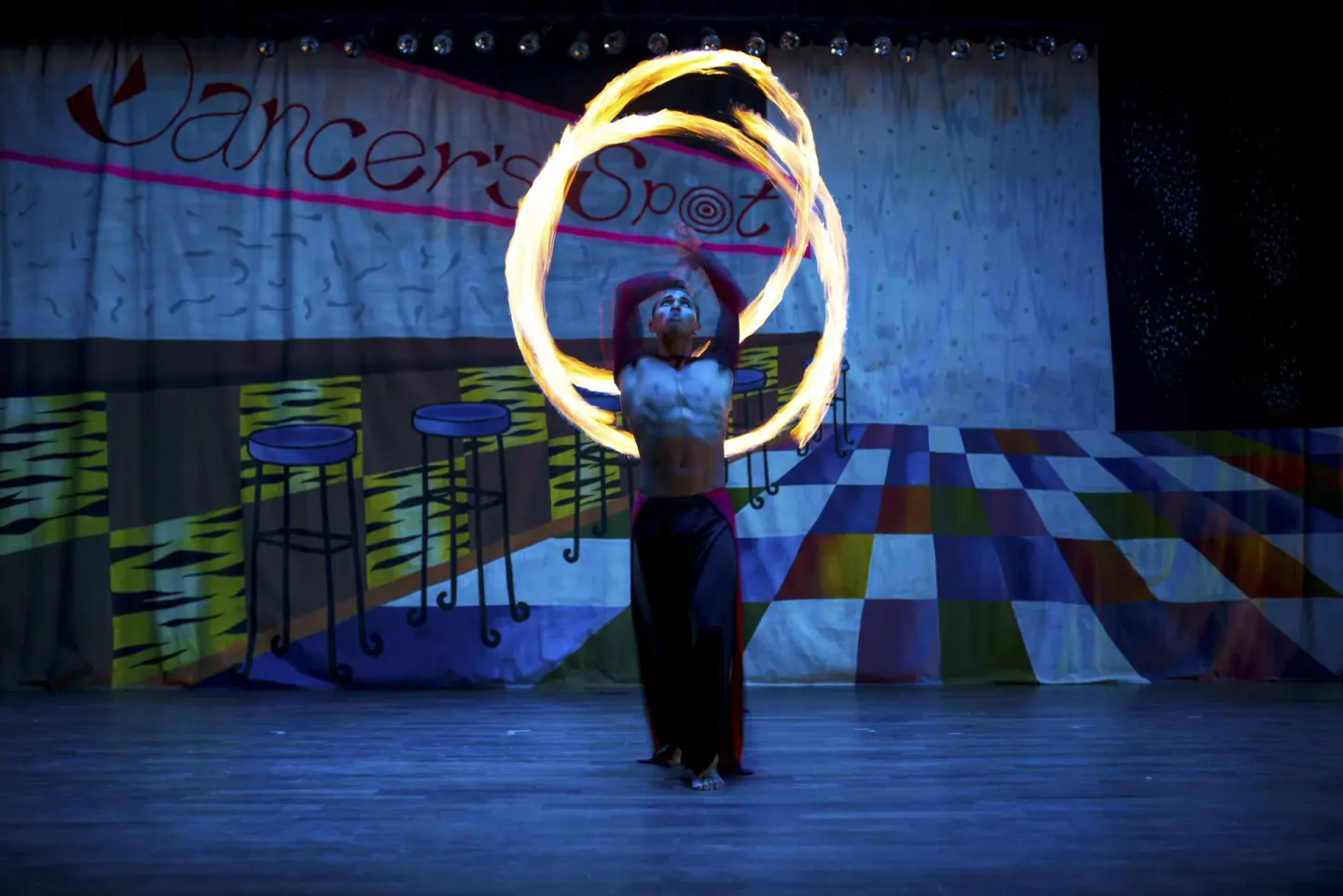Fire performer on stage during evening entertainment at Crown Paradise Golden Resort.