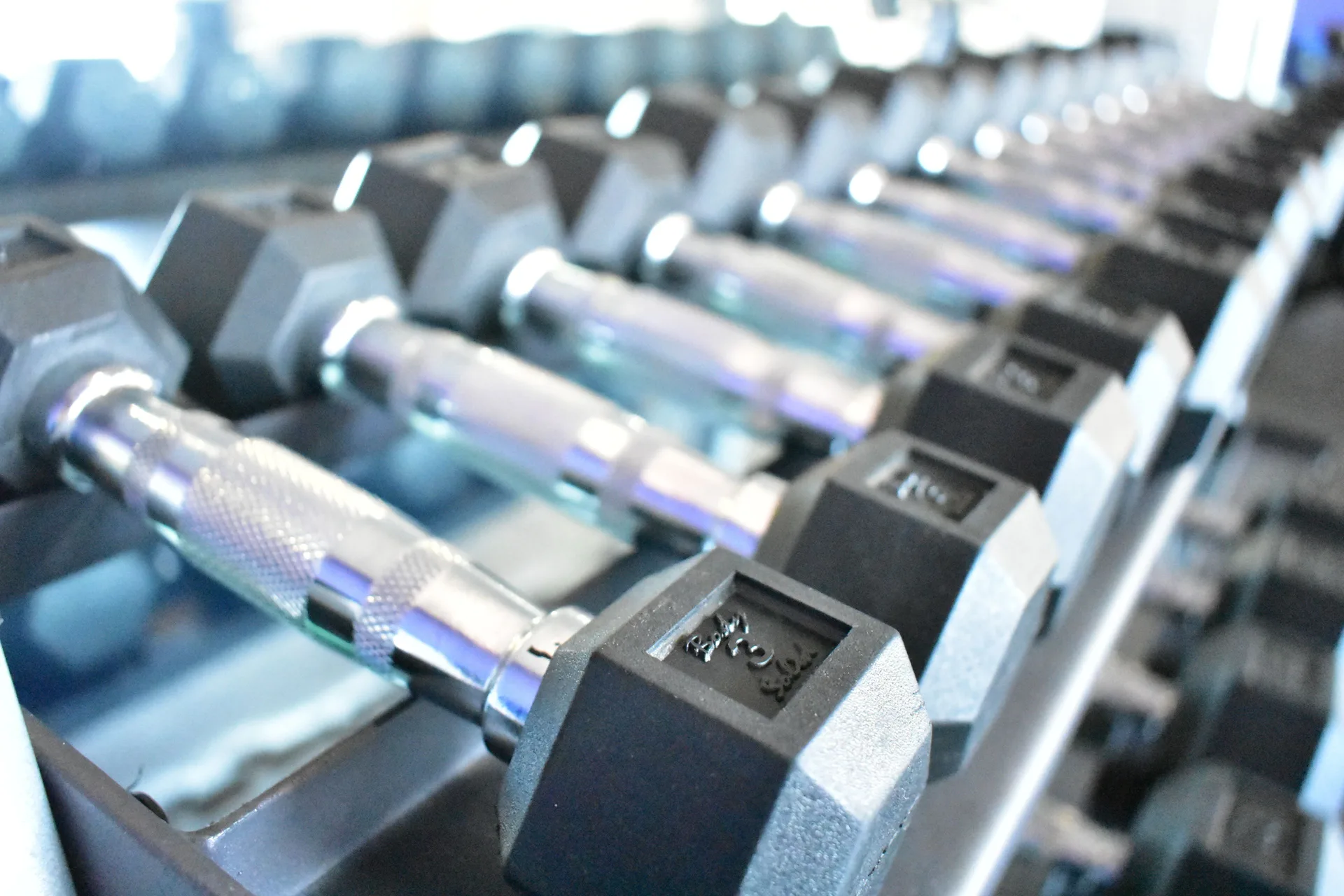 Close-up of dumbbells on a rack in the fitness room at Crown Paradise Golden Resort.