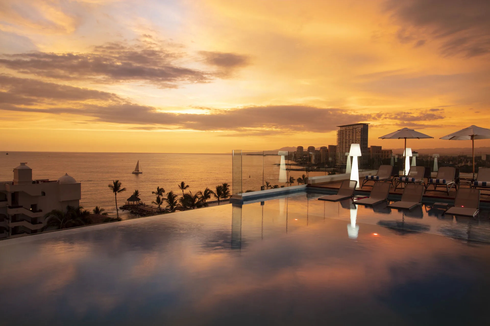 Rooftop pool terrace at sunset at Crown Paradise Golden Resort.