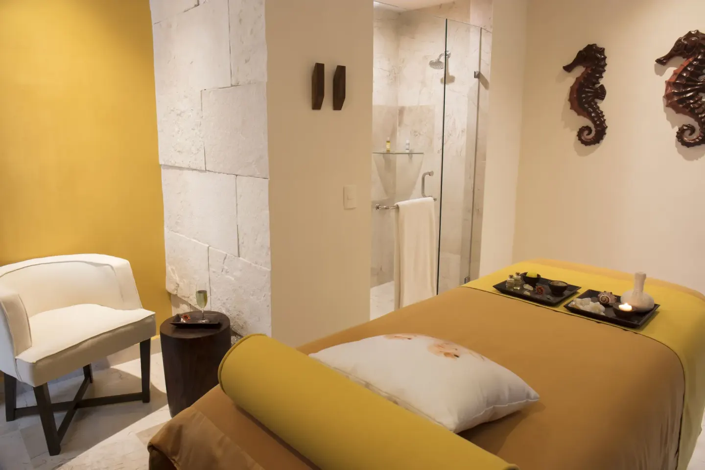 Spa treatment room with massage table and shower at Crown Paradise Golden Resort.