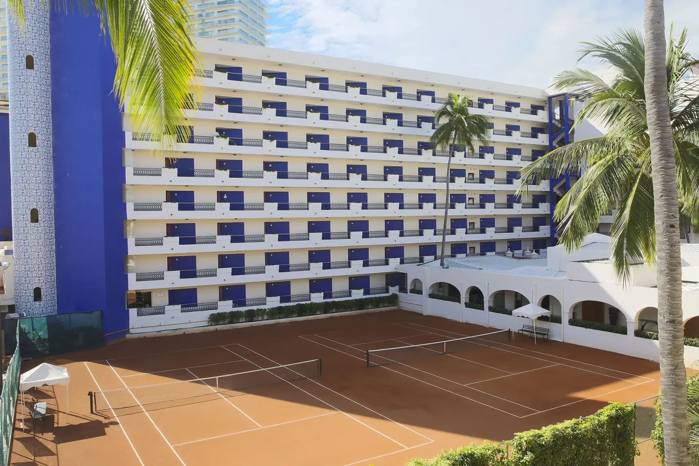 Tennis courts beside the guestroom building at Crown Paradise Golden Resort.