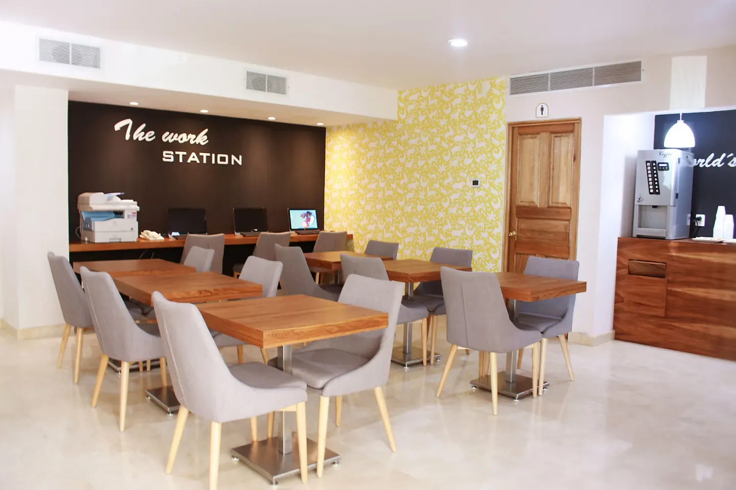 Work station with tables, computers, and coffee service at Crown Paradise Golden Resort.