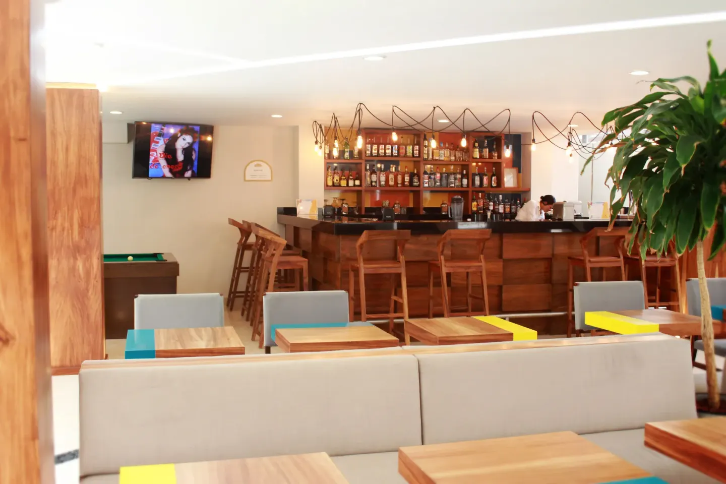 Wood bar, lounge seating and a billiards table at Crown Paradise Golden Resort.