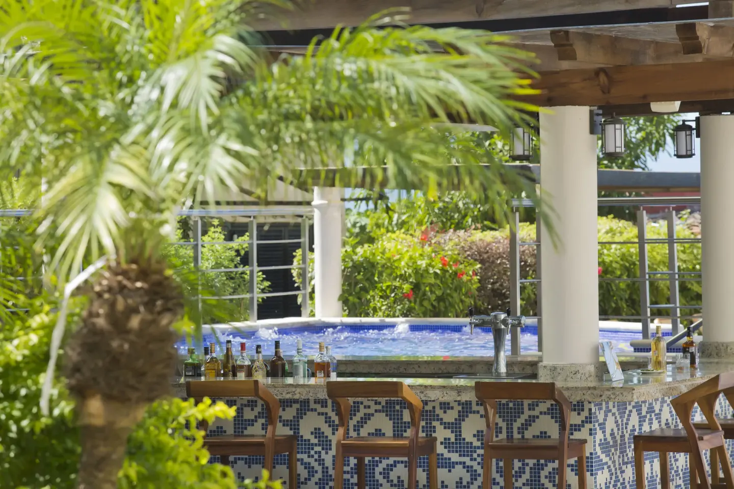 Swim-up pool bar with tiled counter and stools at Crown Paradise Golden Resort.