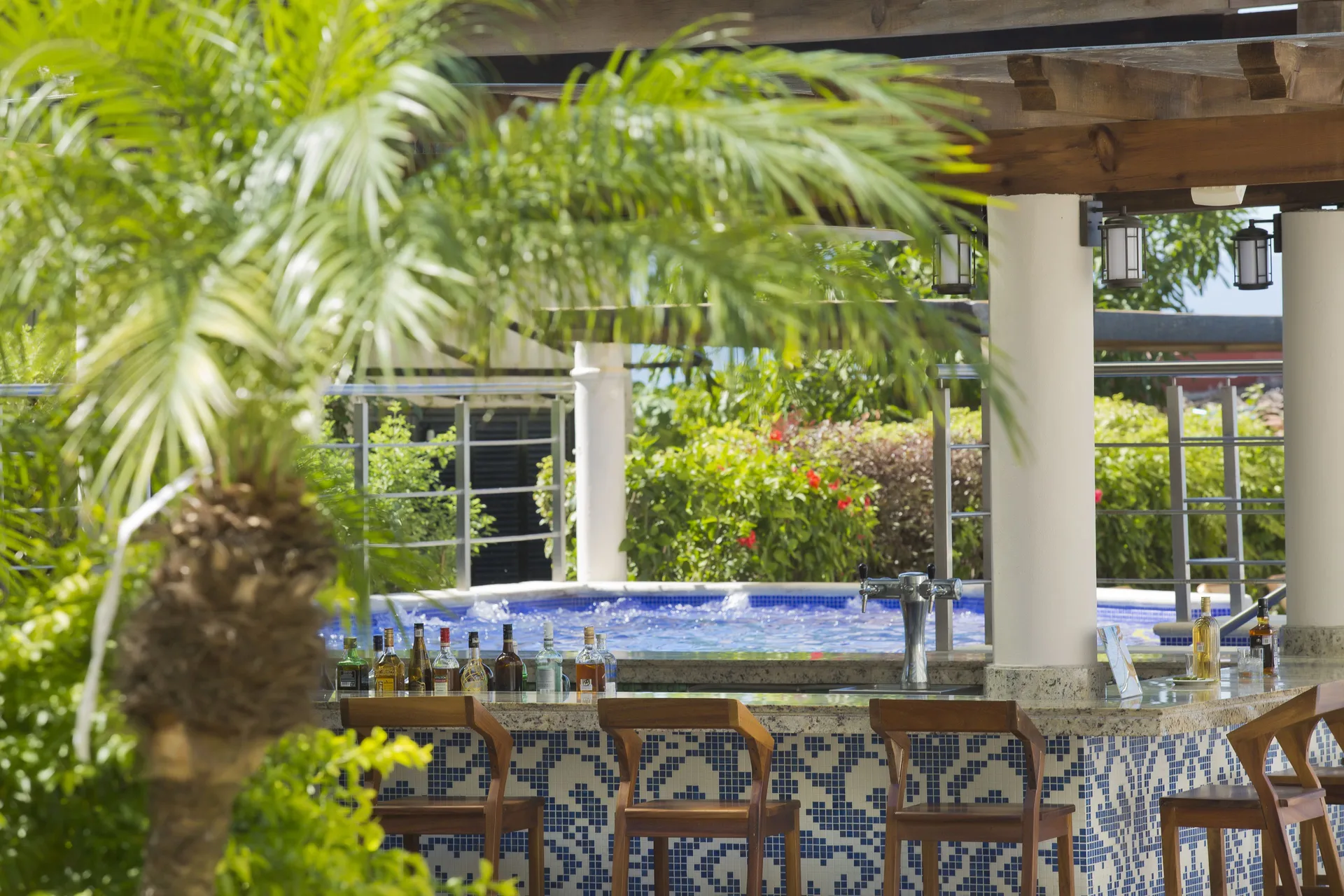 Swim-up pool bar with tiled counter and stools at Crown Paradise Golden Resort.