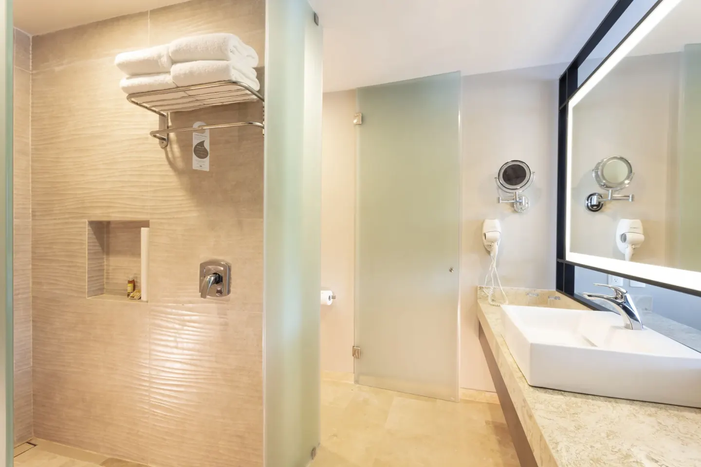 Deluxe Room bathroom with shower, towels, and sink at Crown Paradise Golden Resort.